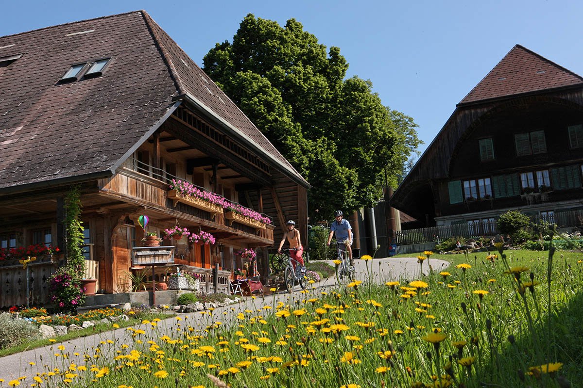Cycling holiday in Emmental - riding past traditional challet